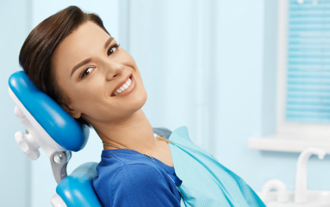 Woman with beautiful smile in a dental chair